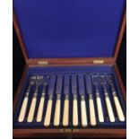 AN EARLY 20TH CENTURY MAHOGANY CASED SET OF FISH KNIVES AND FORKS With silver plated blades, with