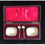 A CASED SET OF EARLY 20TH CENTURY ENGLISH HALLMARKED SILVER SALTS AND SPOONS.
