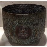 AN EARLY 20TH CENTURY HAND BEATEN BRASS AND COPPER JARDINIÈRE Decorated with gods and worshipers,