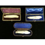 THREE VICTORIAN PEN KNIVES With hallmarked silver blades and mother of pearl handles, cased.