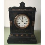 A VICTORIAN BLACK AND ROUGE MARBLE CHIMING MANTLE CLOCK With floral engraved decoration.