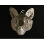 A 19TH CENTURY BRONZE STUDY of a foxes head with red glass eyes. 15cm