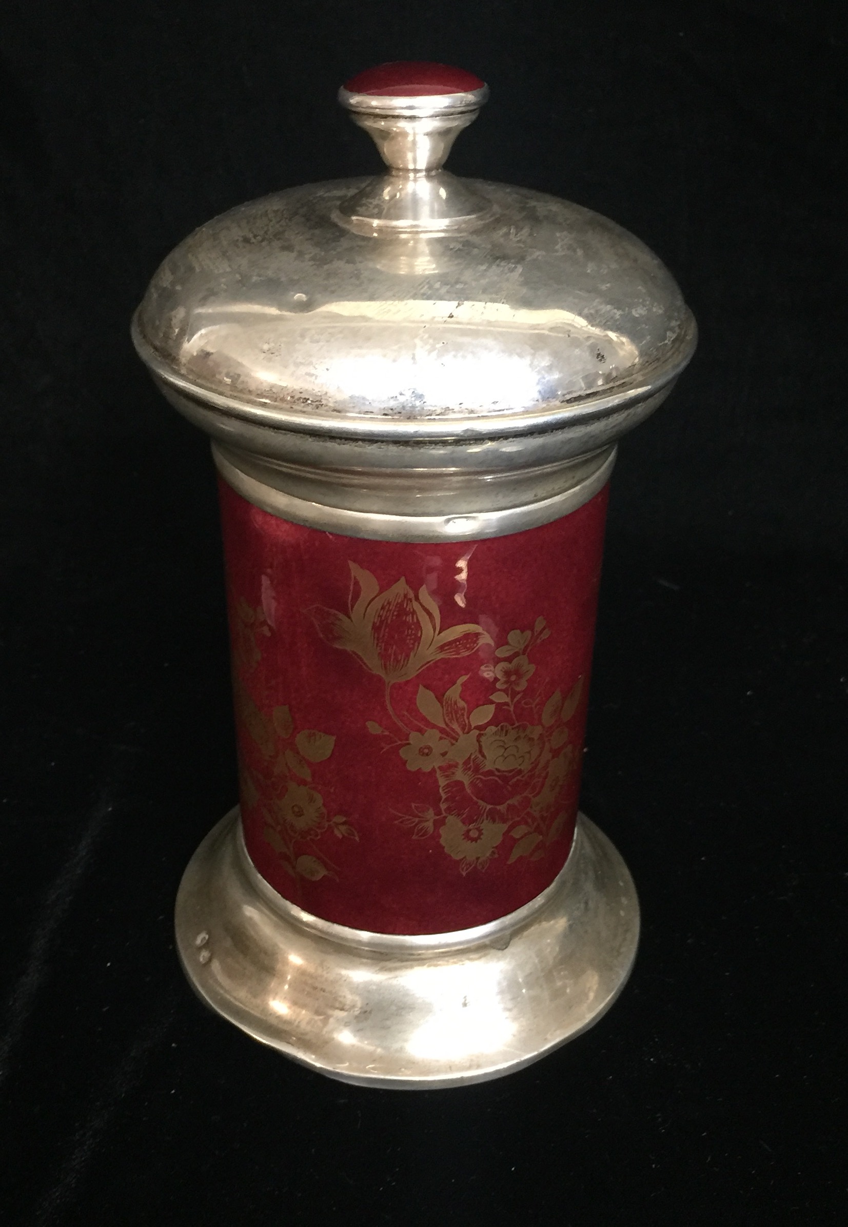 A CONTINENTAL WHITE METAL AND RED ENAMELLED CANISTER With gilded floral decoration. (20cm)