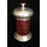 A CONTINENTAL WHITE METAL AND RED ENAMELLED CANISTER With gilded floral decoration. (20cm)