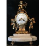 A LATE VICTORIAN GILT BRONZE CLOCK Figured with three cherubs with a circular floral enamelled dial,