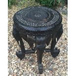 A LATE 19TH/EARLY 20TH CENTURY EBONISED OCCASIONAL TABLE The circular floral carved top, raised on