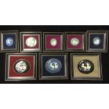 A COLLECTION OF CERAMIC OVAL ROUNDELS Decorated with classical scenes, mounted and framed.