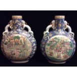 A LARGE PAIR OF CHINESE FAMILLE ROSE PORCELAIN MOON FLASKS With blue grounds and central circular