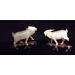 A PAIR OF 20TH CENTURY CHINESE JADE CARVINGS Modelled as goats with long hair and horns, having