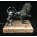 A 19TH CENTURY DESK BRONZE STATUE A classical lion standing on a rouge marble base. (14cm x 12cm not