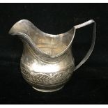 A GEORGE III SILVER CREAM JUG Of classical shape, with baluster body and reeded handle and rim,
