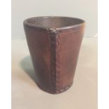 AN ANTIQUE ENGLISH BROWN LEATHER DICE CUP The tapering body with four decorative bands and