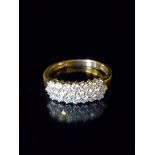 AN 18CT GOLD AND DIAMOND CLUSTER DRESS RING Three rows of round cut diamonds pavé set, in white gold