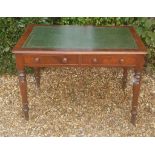 A VICTORIAN MAHOGANY WRITING TABLE With a green tooled leather top above two short drawers, raised