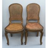 A PAIR OF LATE VICTORIAN GILTWOOD MUSIC CHAIRS With caned slats and backs. ?40-60
