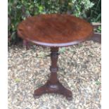A VICTORIAN MAHOGANY OCCASIONAL TABLE The circular top on a turned column support over a triform