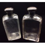 THREE EARLY 20TH CENTURY SILVER AND CUT GLASS EAU DE COLOGNE BOTTLES Of rectangular shape, with