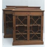 WARING & GILLOW, A PAIR OF EARLY 20TH CENTURY WALNUT BOOKCASES With deep cushion back rails above