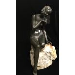 AN ART DECO PERIOD BRONZE STATUE A nude female bather on natural rock base. (28cm)