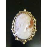 A LARGE 20TH CENTURY 18CT GOLD AND SHELL CAMEO BROOCH Portrait of a lady with flowing hair set
