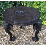 AN EARLY 20TH CENTURY INDIAN HARDWOOD OCCASIONAL TABLE The circular top with carved figure of a