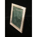 AN EARLY 20TH CENTURY GERMAN SILVER PHOTOGRAPH FRAME With an easel style back and engine turned