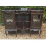 A 19TH CENTURY EBONISED CHIFFONIER The shaped top over two serpentine fronted shelves, flanked by