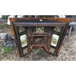 A VICTORIAN AESTHETIC MOVEMENT CAST IRON FIRE PLACE INSET With floral and pictorial tiles, perched