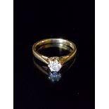AN 18CT GOLD AND DIAMOND SOLITAIRE RING The brilliant cut diamond claw set to plain tapering