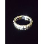 A PLATINUM AND DIAMOND HALF HOOP/WEDDING ETERNITY RING The plain platinum band inset to front,