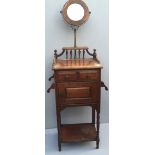 AN EDWARDIAN BEECH WOOD SHAVING STAND With circular mirror above gallery, two drawers and cupboards.