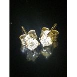 A PAIR OF 9CT WHITE GOLD AND DIAMOND STUD EARRINGS The brilliant cut diamonds claw set to post and