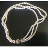 A TRIPLE STRAND CULTURED PEARL NECKLACE With diamond set clasp, three rows of graduated cultured