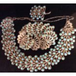 A VINTAGE WHITE METAL AND TURQUOISE SUITE OF JEWELLERY To include a necklace, bracelet and brooch