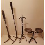 TWO ANTIQUE IRON CANDLE STANDS Along with a single pricket and twin branch pricket stick.