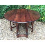 BRIGHTS OF NETTLEBED, A 17TH CENTURY STYLE OAK DROP LEAF DINING TABLE With double gate leg action,