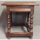 A 19TH CENTURY OAK RECTANGULAR JOINT STOOL With turned legs and peg joints. (approx 45cm x 47cm)
