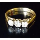 AN EARLY 20TH CENTURY 18CT GOLD AND DIAMOND THREE STONE RING The three uniform old mine cut diamonds