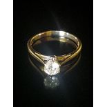 A HALLMARKED 18CT GOLD AND DIAMOND SOLITAIRE RING The brilliant cut diamond claw set to plain