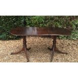 A REGENCY DESIGN 'D' END DINING TABLE With one extra leaf and raised on turned columns, with splayed