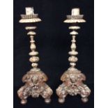 A PAIR OF 17TH CENTURY ITALIAN LIME WOOD CANDLESTICKS Dished sconces above acanthus leaf decoration,