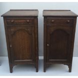 TWO EARLY 20TH CENTURY OAK BEDSIDE CABINETS With single drawers above arched panelled doors.