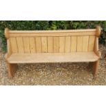 A VICTORIAN PINE THREE SEAT PEW The tongue and groove panelled back above a solid seat, with
