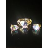 A 10CT GOLD AND MYSTIC TOPAZ DRESS RING AND MATCHING STUD EARRINGS The ring is an oval cut topaz