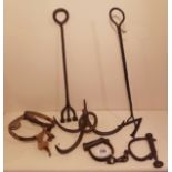A COLLECTION OF 19TH CENTURY IRON ITEMS Comprising a pair of handcuffs, ankle shackles, two