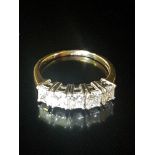 A HALLMARKED 18CT GOLD AND DIAMOND FIVE STONE RING The five uniform Princess cut diamonds claw set