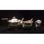A LATE 19TH CENTURY OVAL SILVER TEAPOT With a fluted base, brown handle and finial, with a