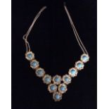 A VINTAGE WHITE METAL AND TURQUOISE NECKLACE Set with twelve cabouchon cut turquoise stones,
