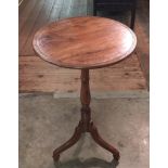 A 19TH CENTURY SOLID YEW OCCASIONAL TABLE the circular top on turned column with spayed legs.