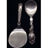 TWO DANISH SILVER AND STAINLESS STEEL SERVING SPOONS Of Rococo design, with scrolling handle,